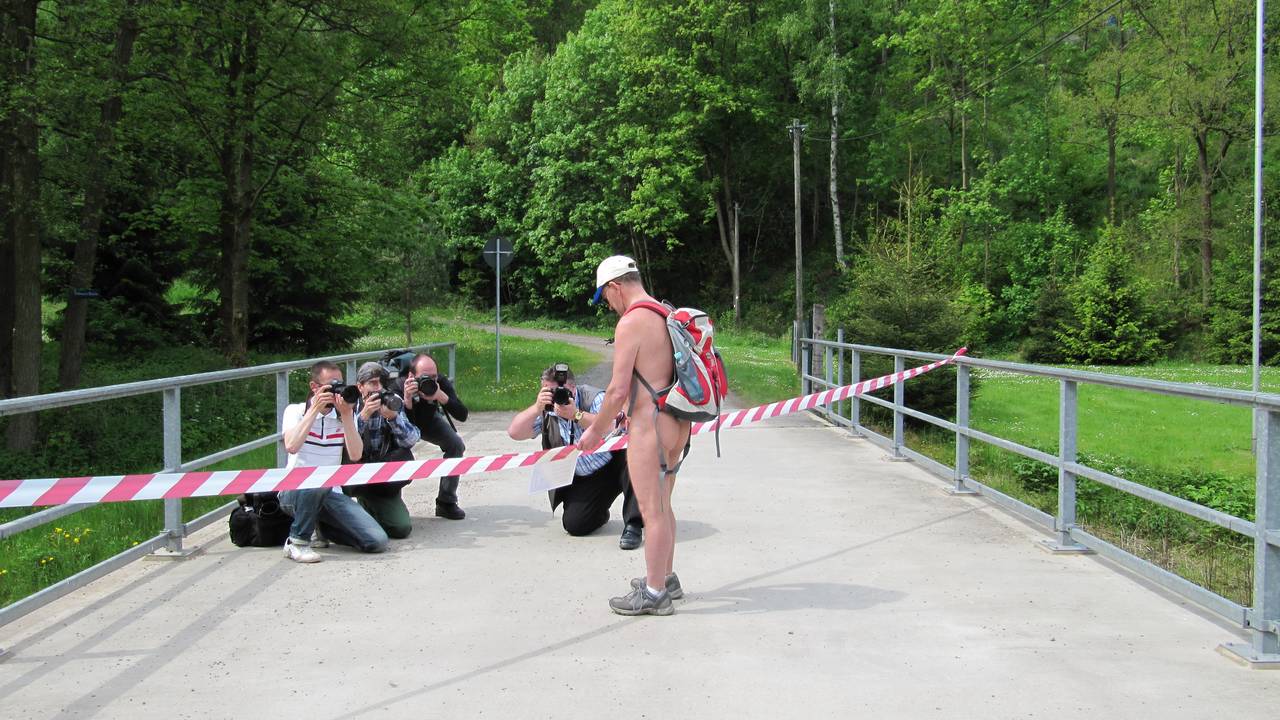 Bild 1: Unter den Linsen der Pressefotografen durschschneidet Horst das Band zur Eröffnung des Naturistenstiegs